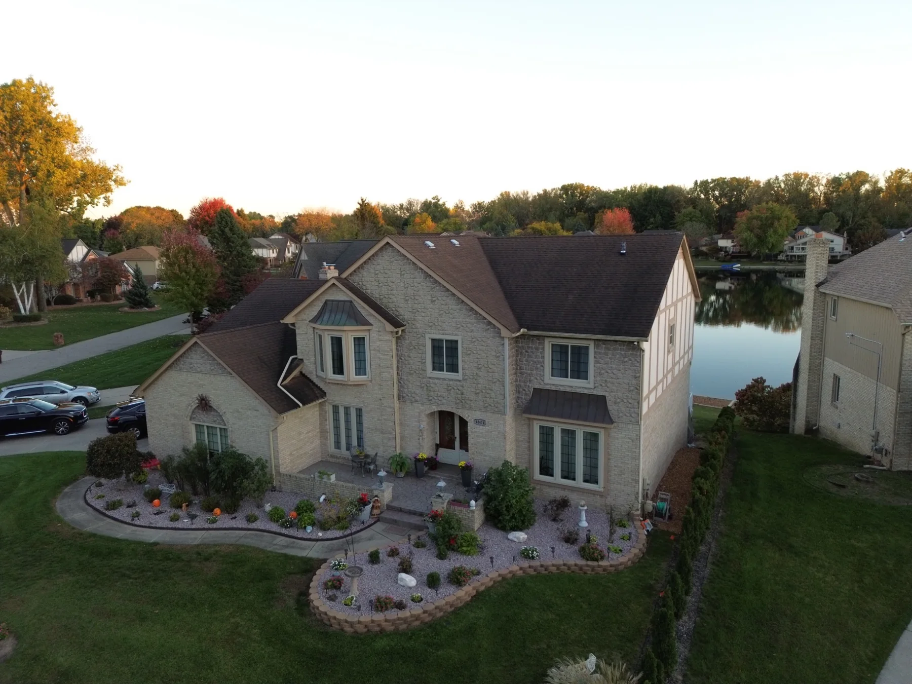 Aerial view of residential home with lake behind it